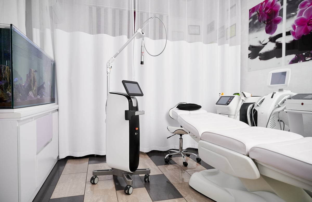 A treatment room with modern skincare and laser equipment
