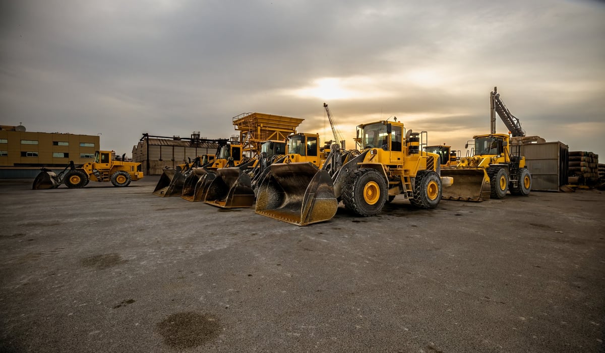 A yellow wheel loader and bulldozer in formation on an earthmoving site