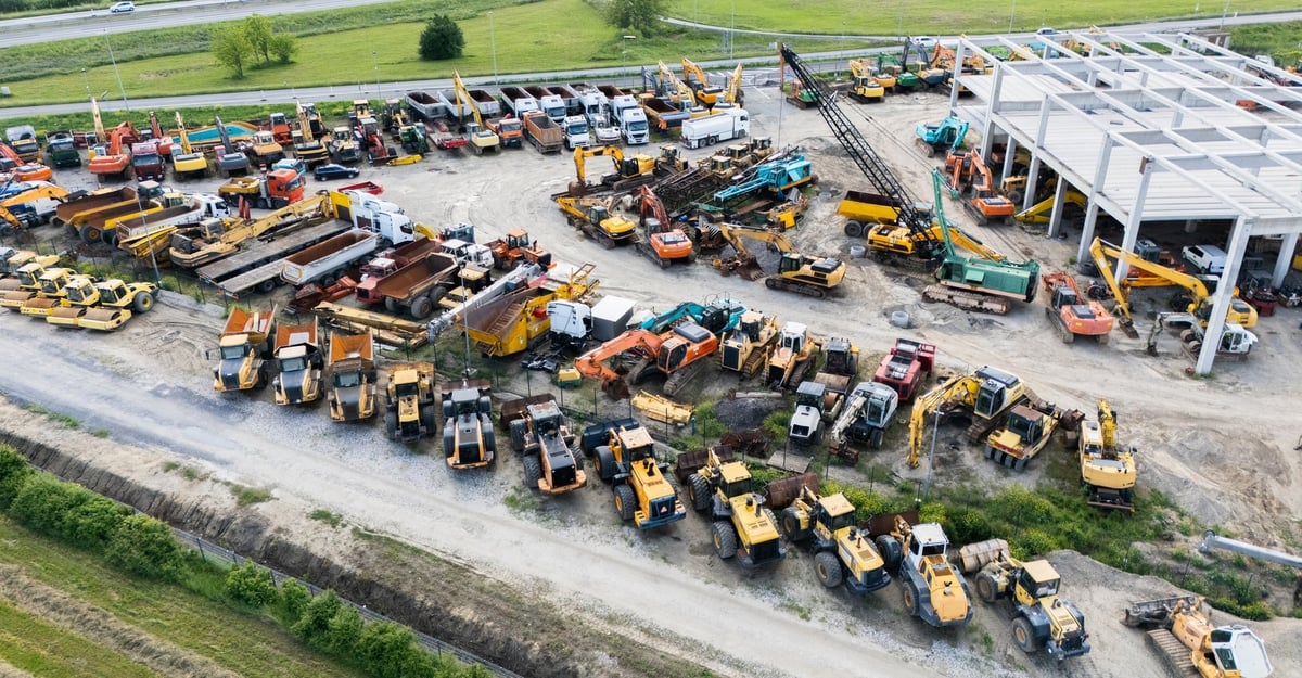 Aerial view of a distribution yard filled with used construction machinery