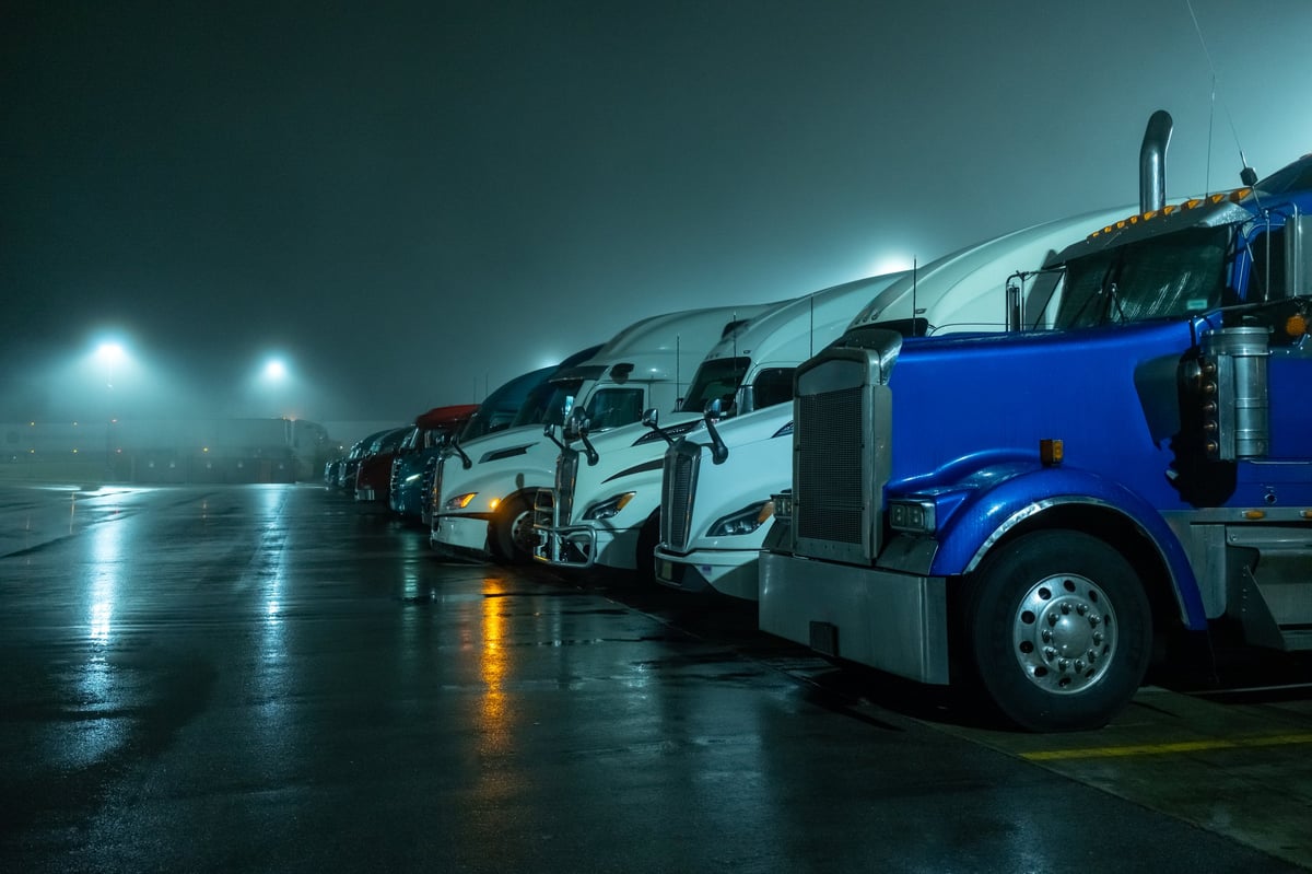 A line of commercial freight trucks parked at a depot, the kind of fleet CBB Group finances for Western Canadian businesses
