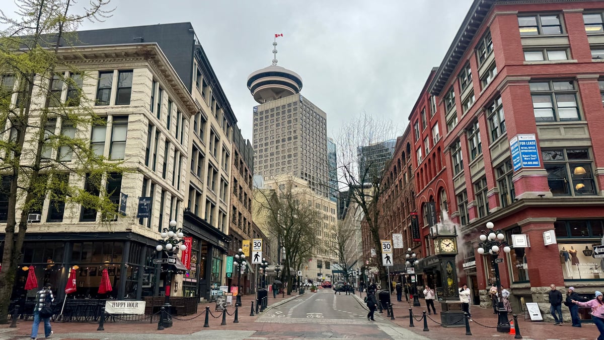 A downtown Vancouver street with historic brick buildings and the Harbour Centre tower, the Western Canadian business community CBB Group funds