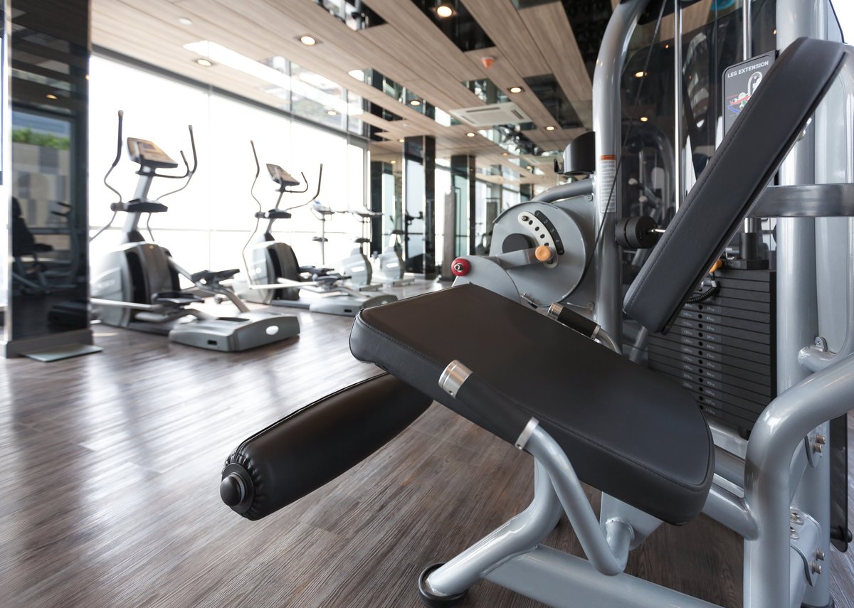 A gym floor filled with a diverse range of cardio and strength training machines, the kind of commercial fitness equipment CBB Group arranges leasing for